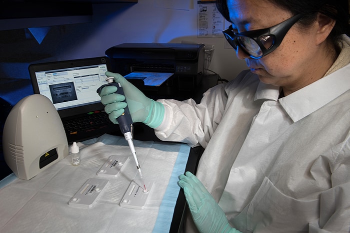 photo of a person in a laboratory performing tests