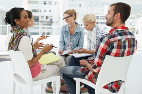 photo of several people working in a conference room