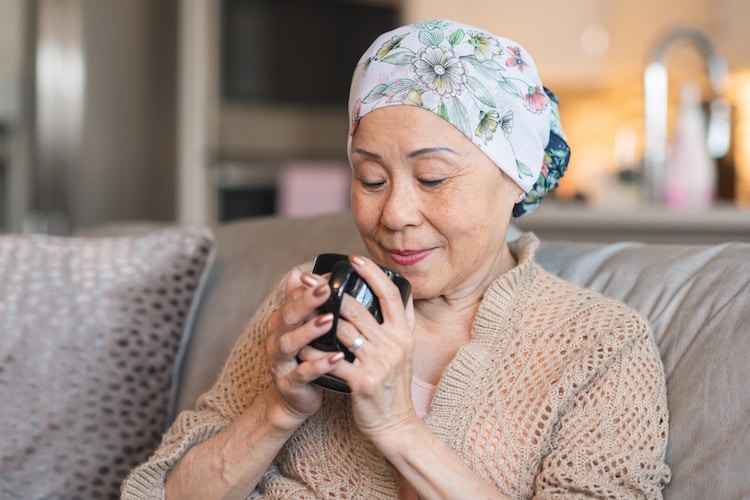 Woman with bandana drinking from a mug