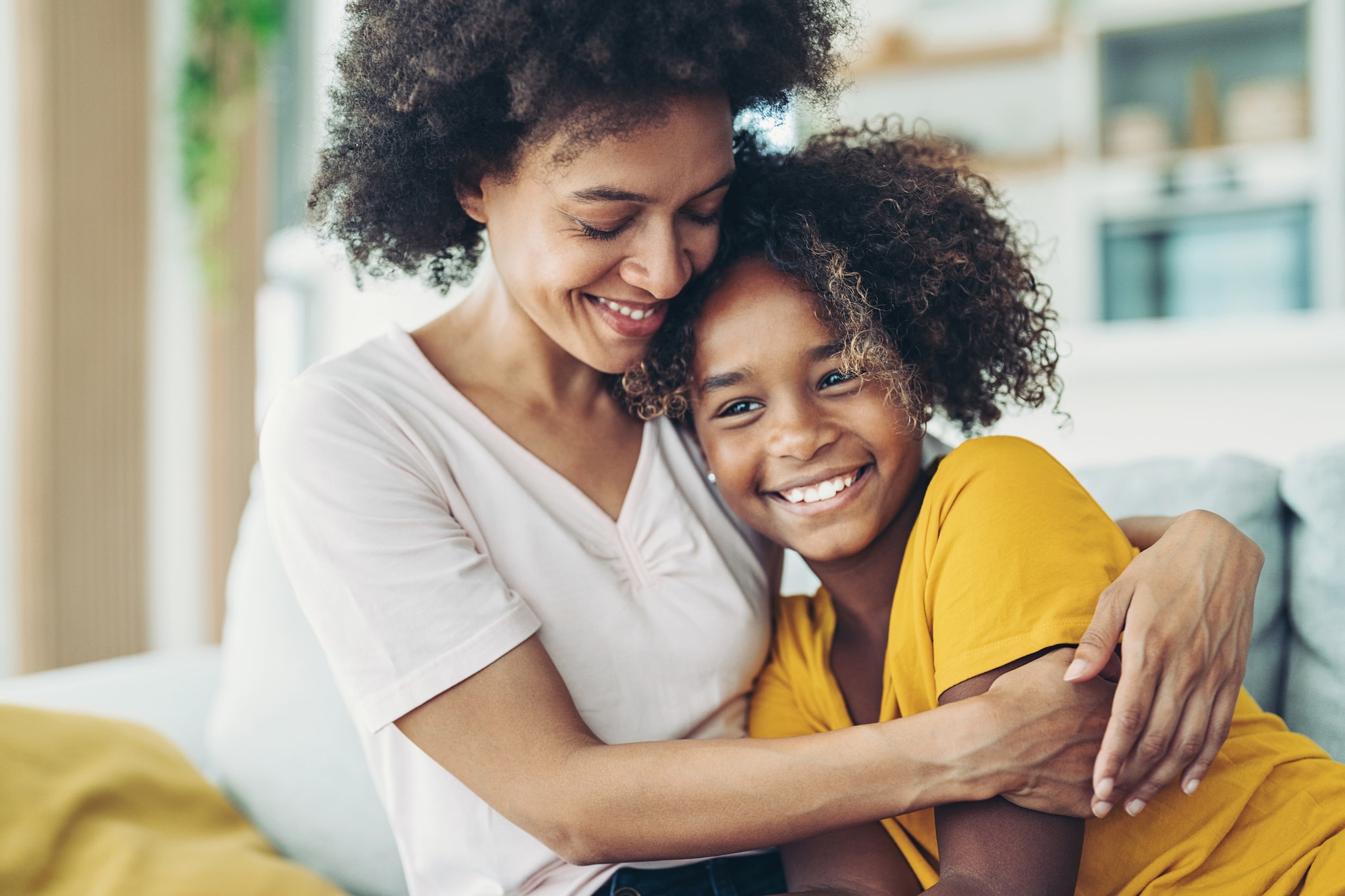 Smiling mother embracing her daughter