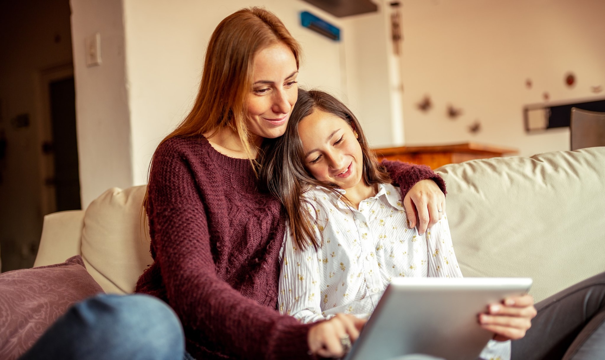 Mother spending time with her daughter on the couch.