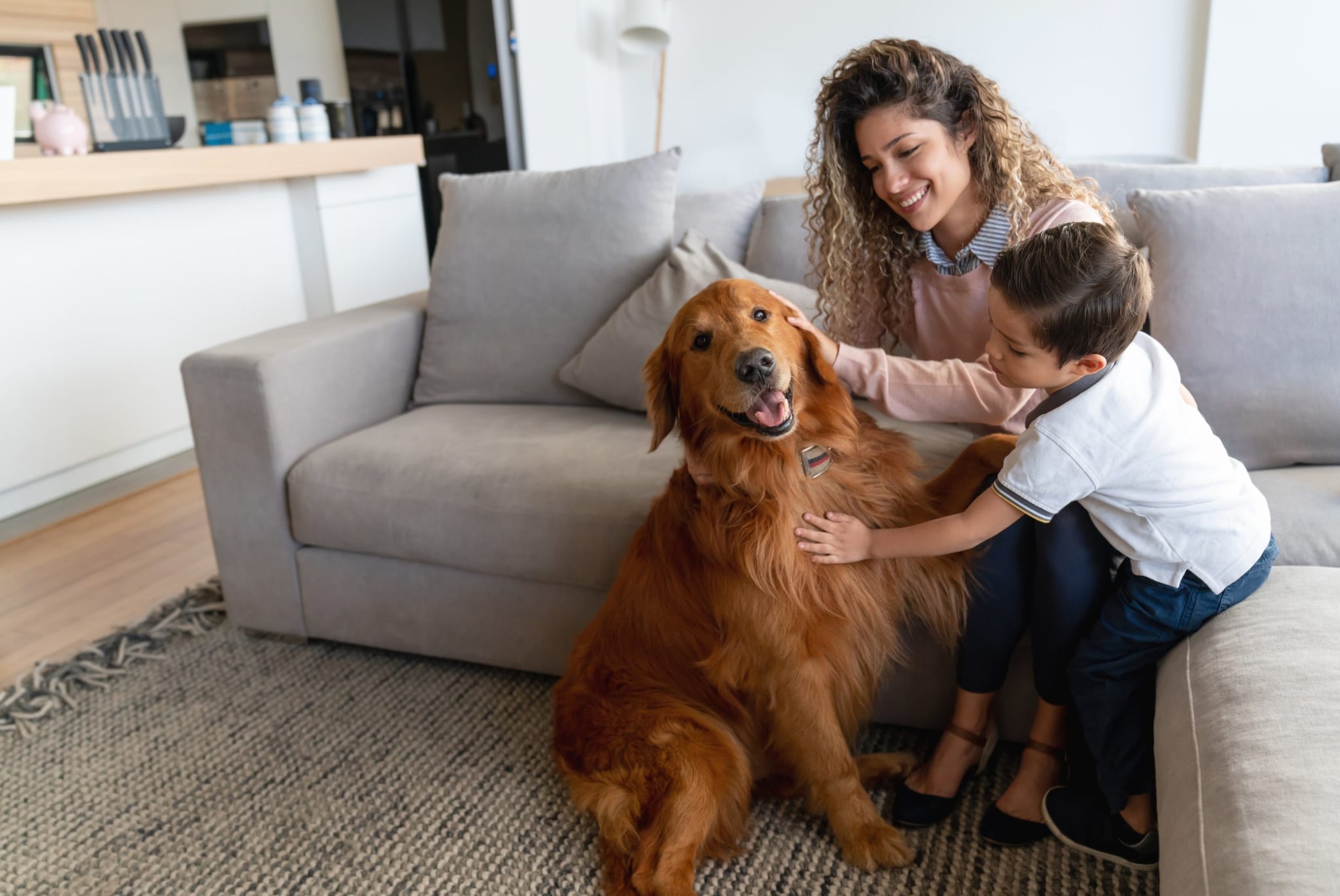 Mother and son at home petting their dog