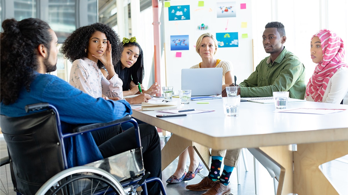 Diverse group discussing with each other in meeting