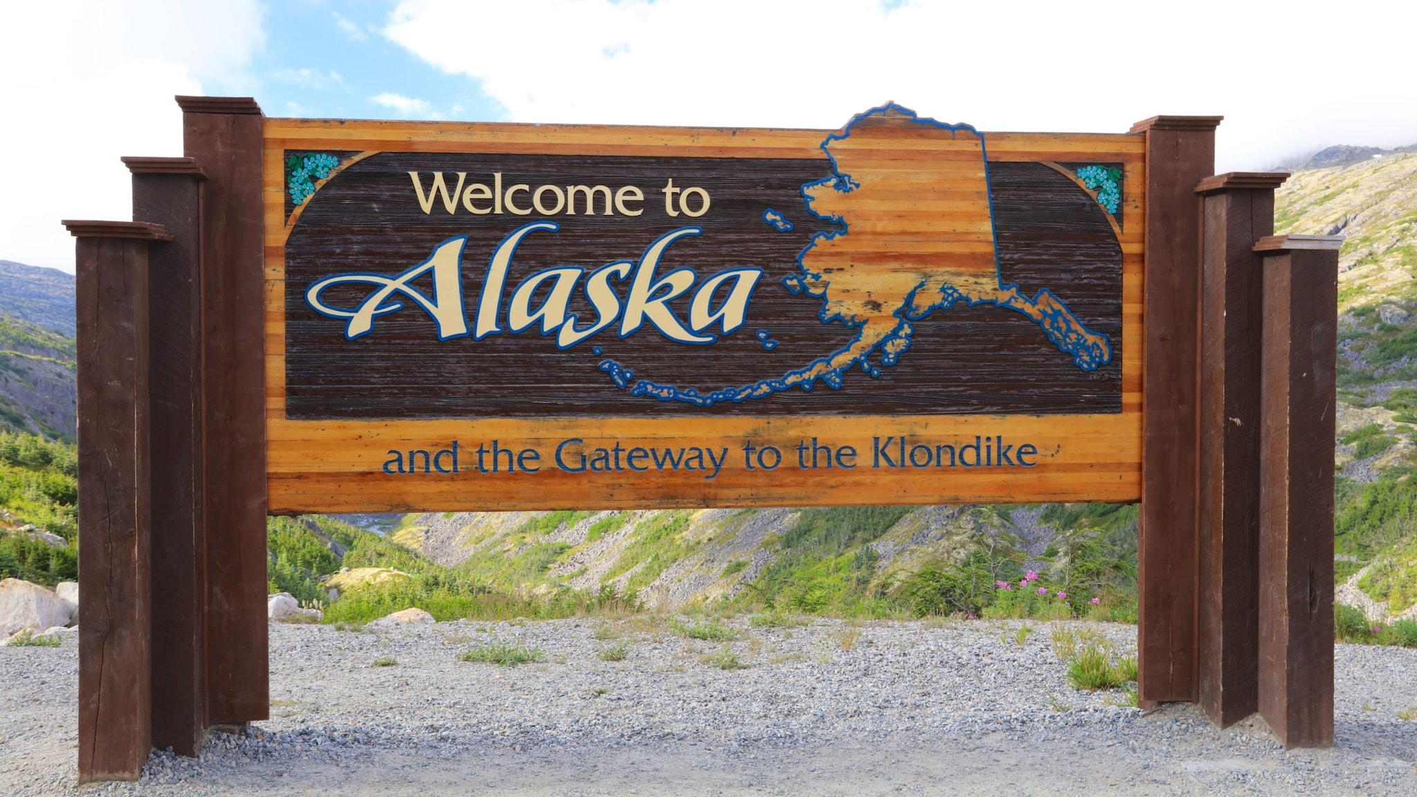 Decorative roadside sign states welcome to Alaska