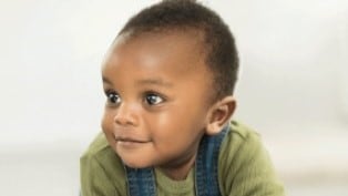 Small baby boy crawling on the floor.