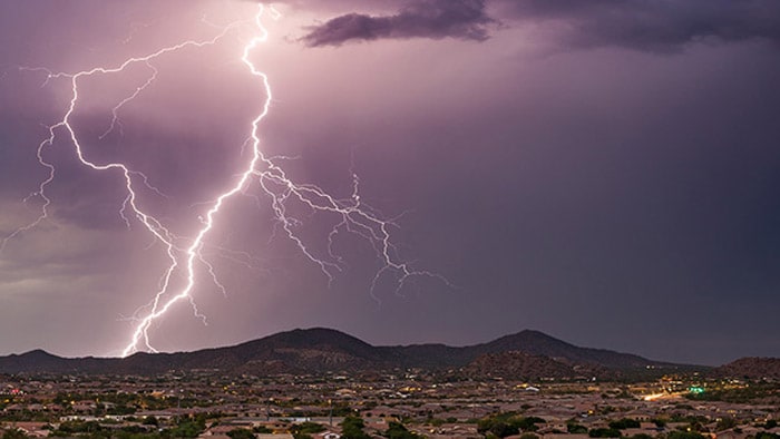 Lightning strike illuminating stormy sky