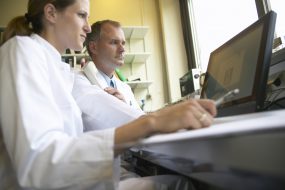 Two doctors looking at computer screen, low angle view