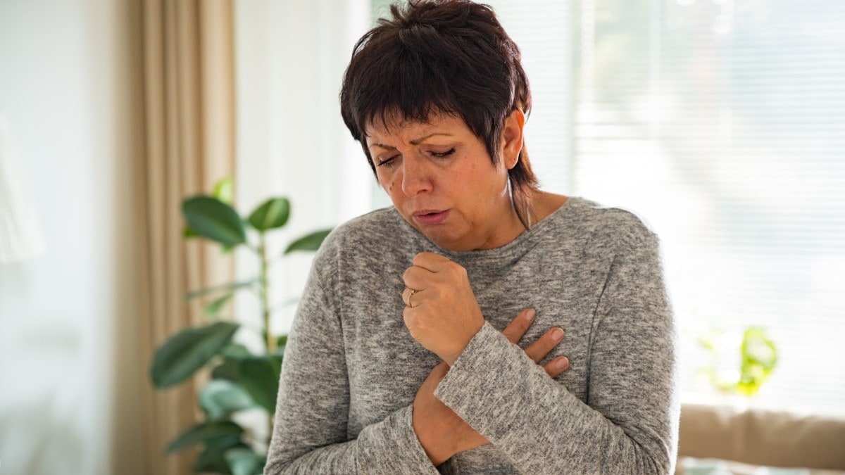 Photo of a woman coughing