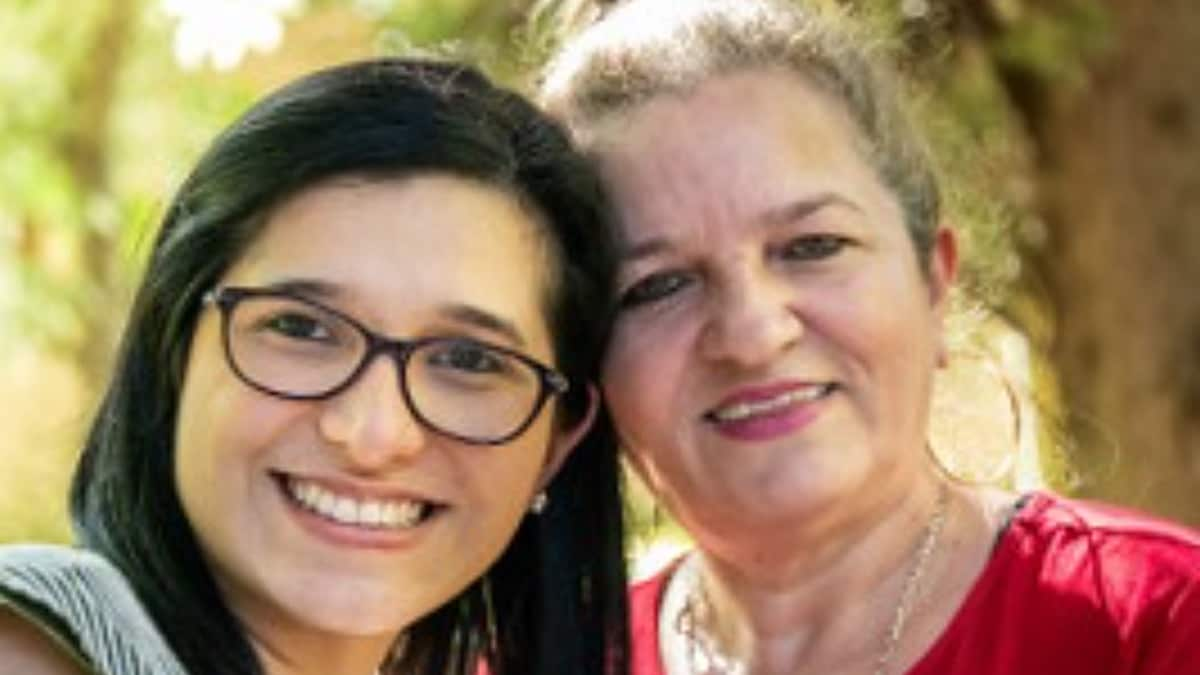 Grandmother and granddaughter standing next to each other.