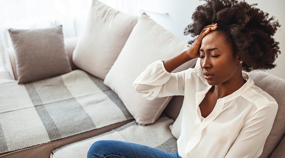 A very tired woman sitting on a couch