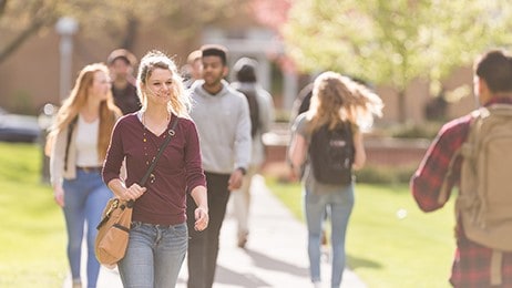 College students walking on the sidewalk to class.