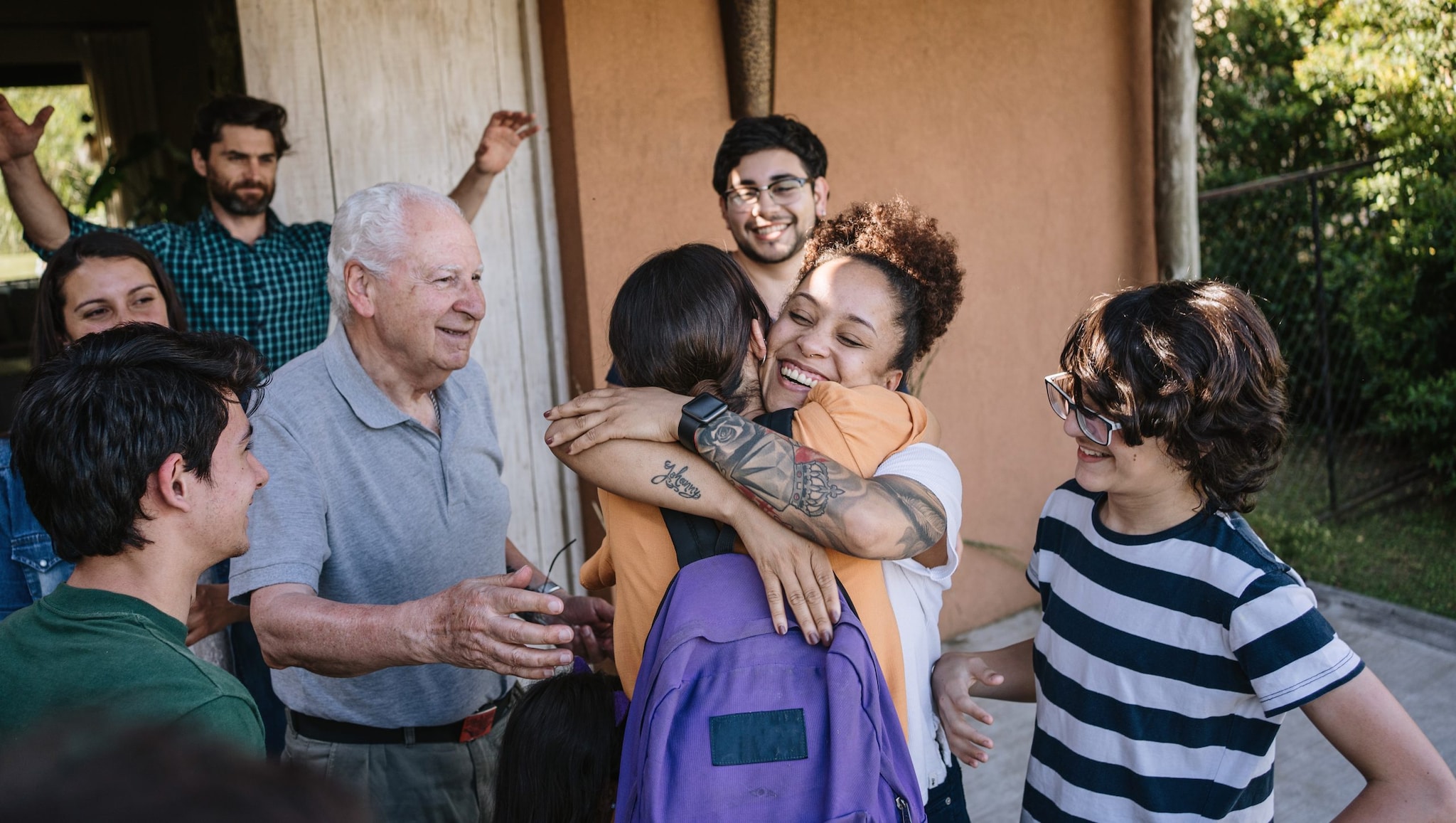 Family greeting their arriving family member.