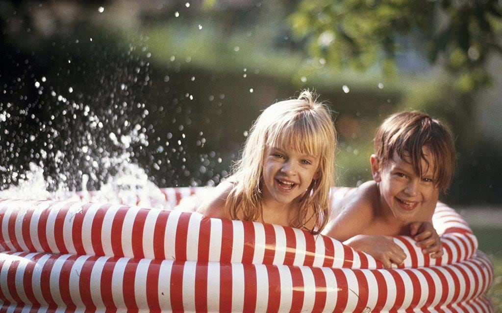 Kids playing in an inflated pool.