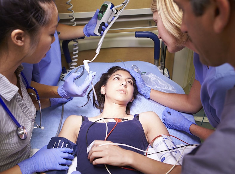 A girl being treated by doctors and nurses in the hospital.