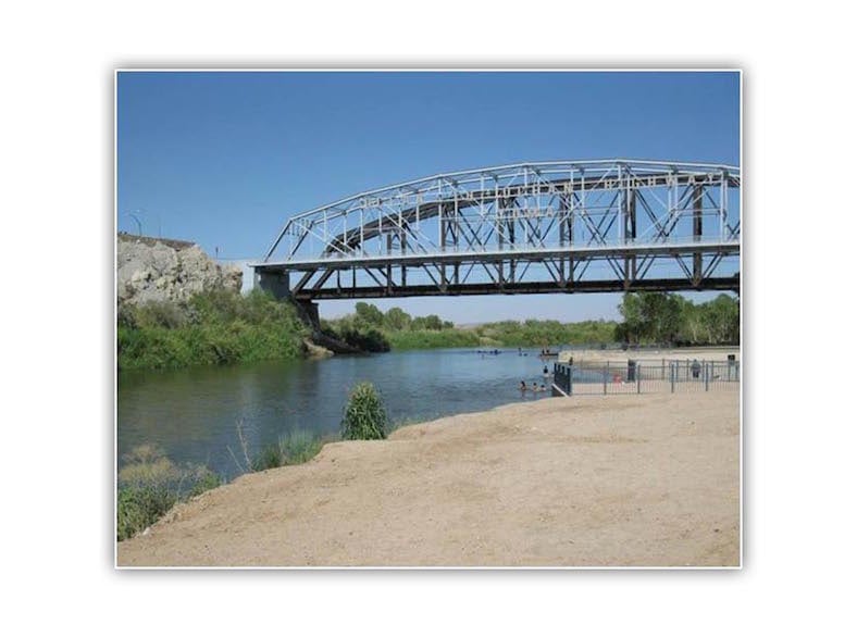 Bridge over river that is a water source for the town