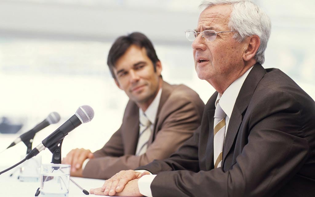 A man speaking at a hearing.