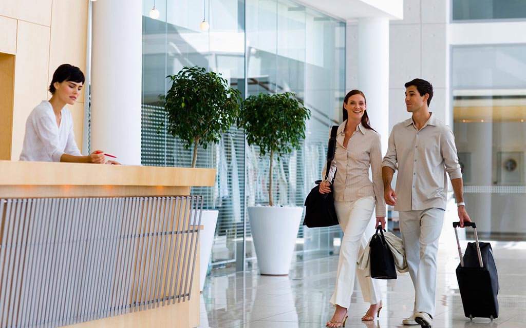 A couple arriving at a hotel lobby.