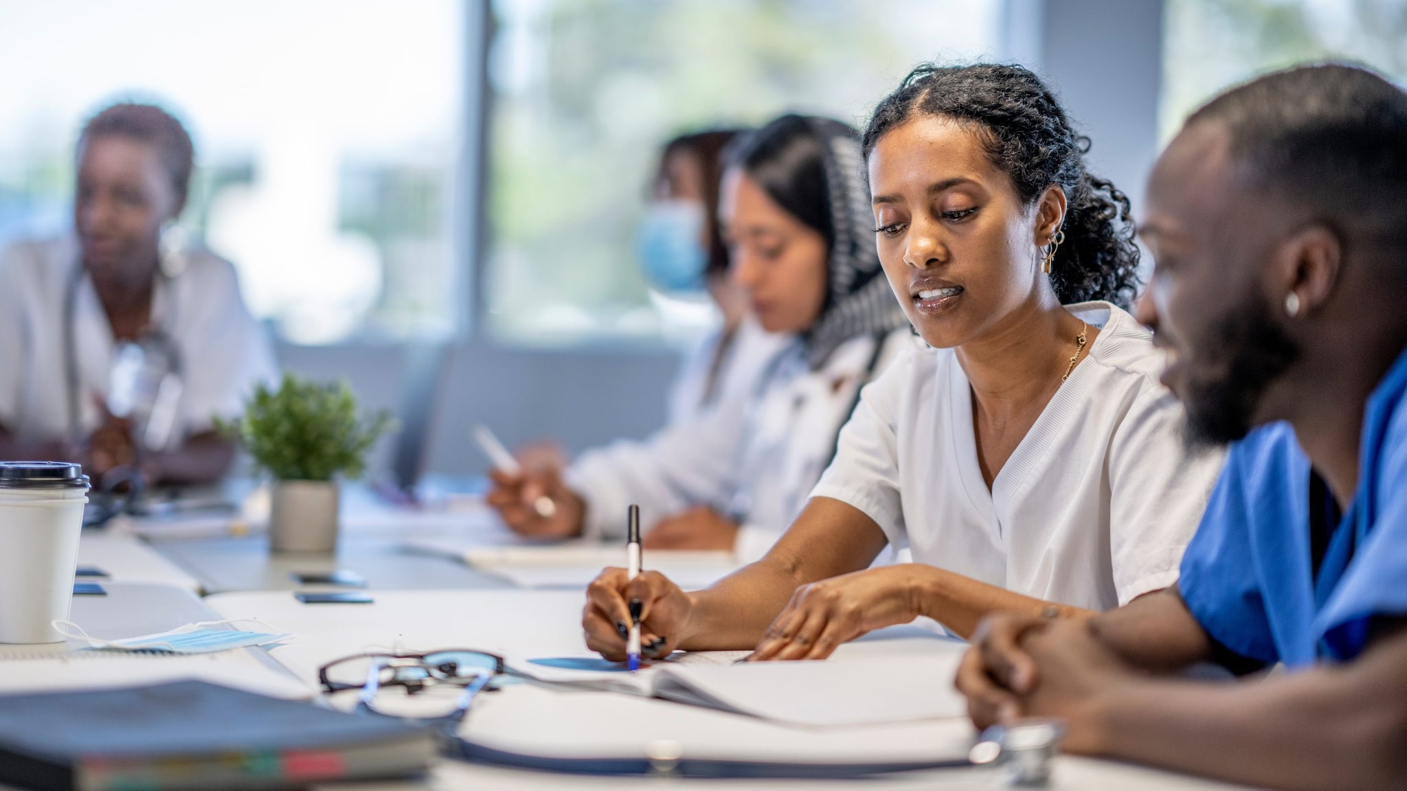 A group of medical professionals meeting at a table