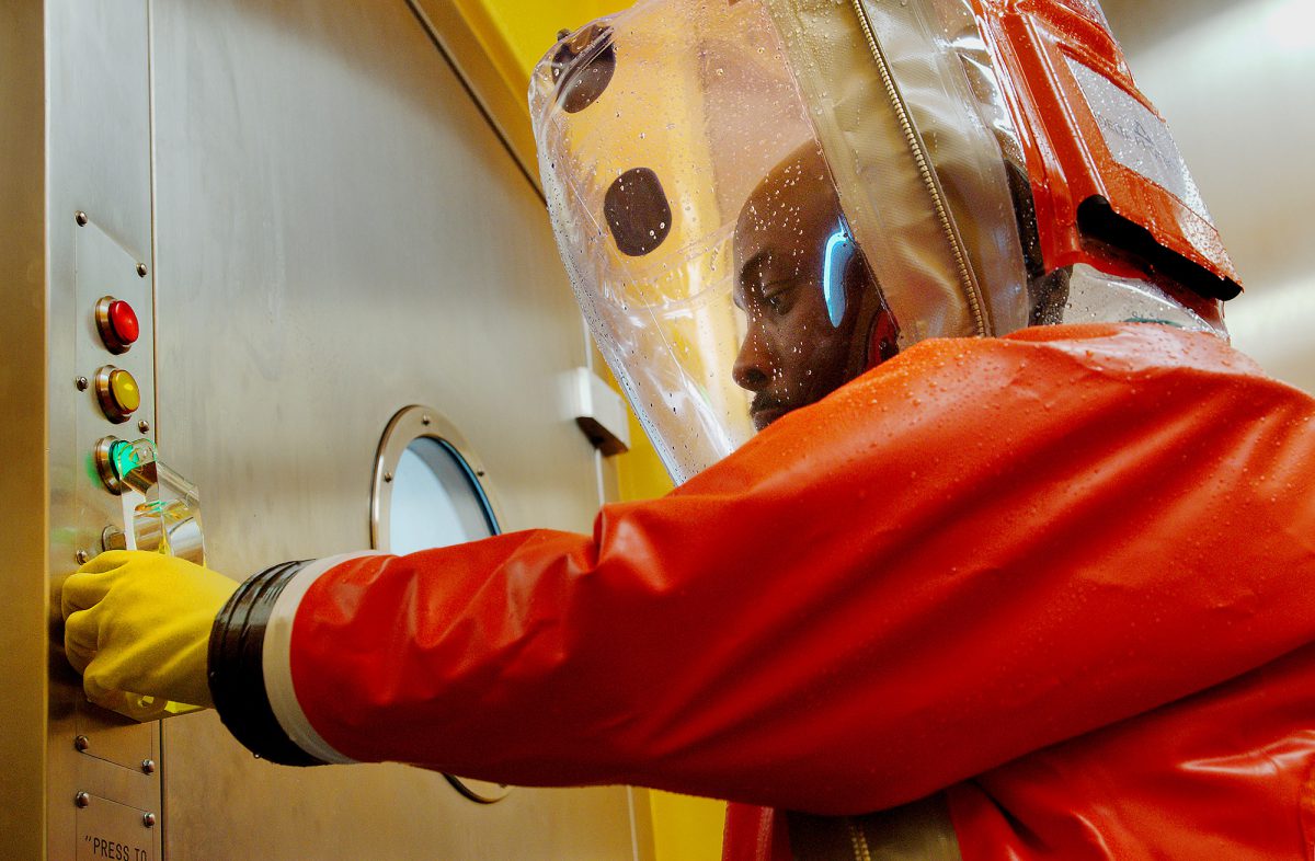 Health scientist in hazard suit