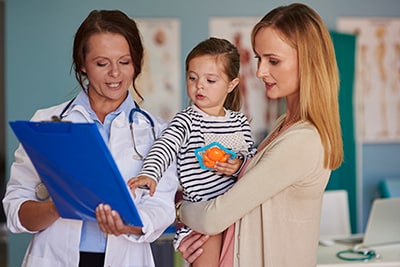 Woman doctor talking with her two patients