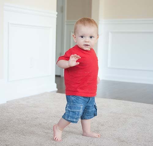 A boy taking a few steps on his own