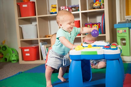 A nine-month-old performing a milestone: stands & holding on