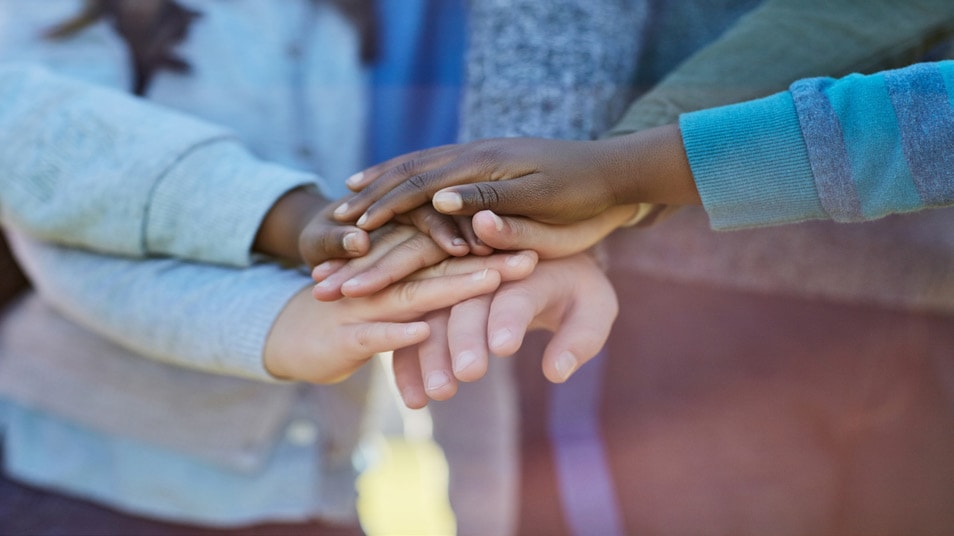 Children putting hands together