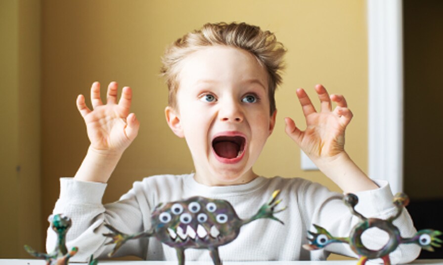 suprised kid raising hands