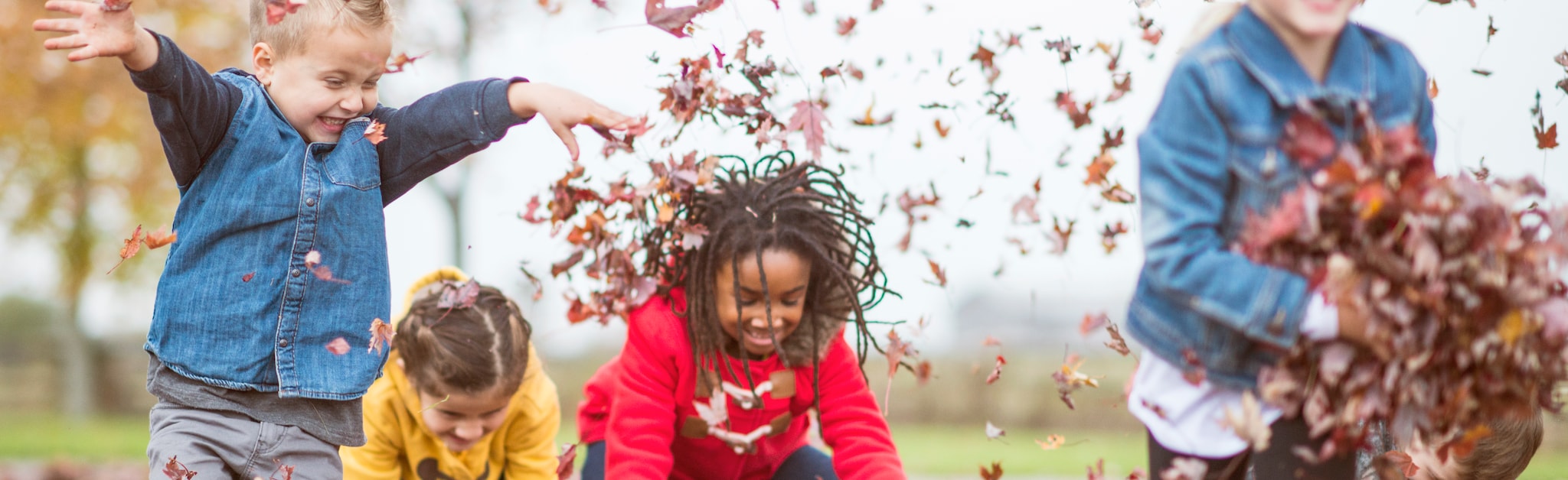 Kids throwing leaves