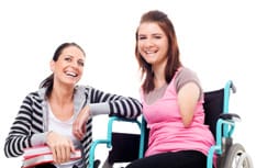 Disabled girl with friend crouching beside her