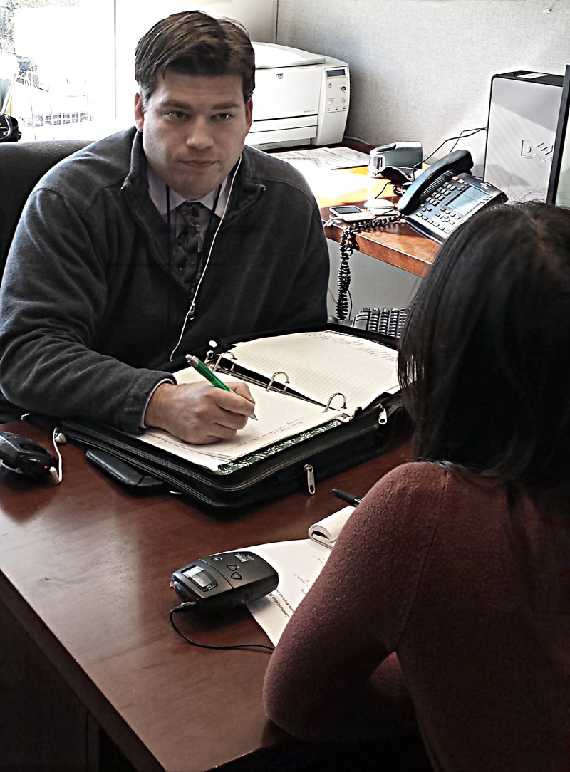 Justin meeting with colleague in his office.