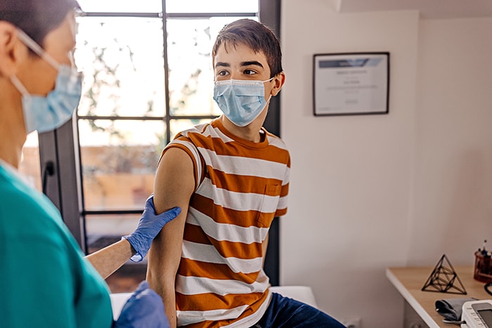 Doctor speaking to child in exam room