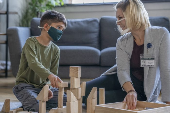 Occupational therapist sitting with a child