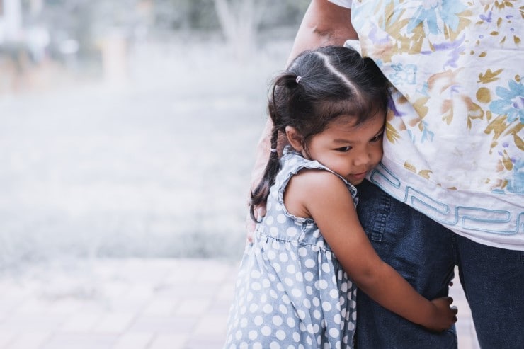 Child hugging her caregiver