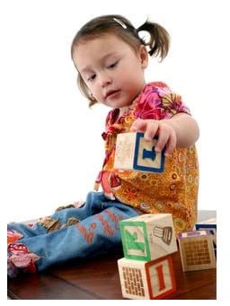 Little girl playing with blocks