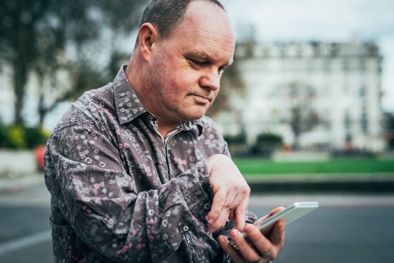 A man with a disability using his cellphone