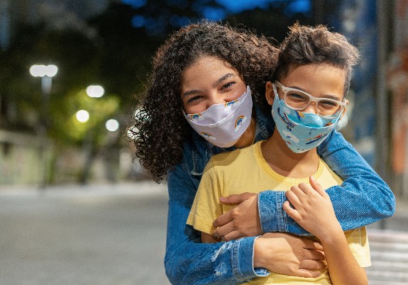 Young adults wearing protective face masks