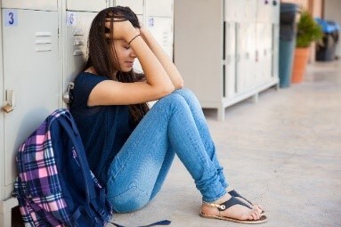 An upset school girl at school.