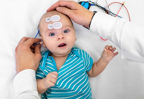 A baby receiving a hearing test