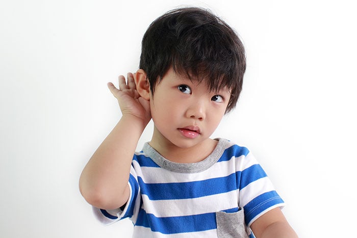 Little Asian boy with a hearing impairment