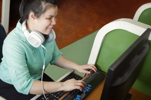 Woman with a vision impairment using a computer