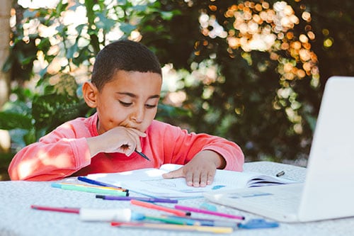 A young boy working at his computer