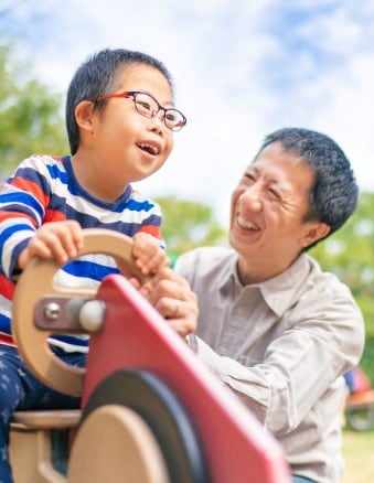 Father and child with disability at the park