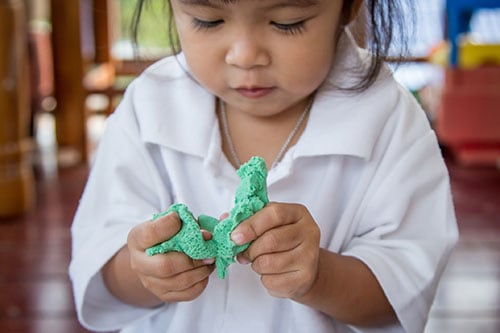 Young girl playing with play doe