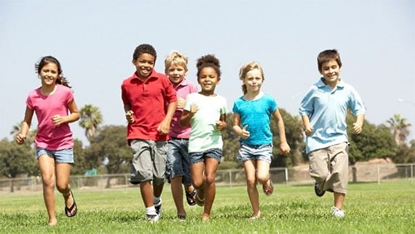 Kids running and playing on a field