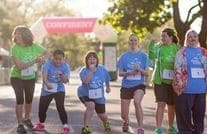 Girls with and without disabilities line up outside to start a race with the program, Girls on the Run.