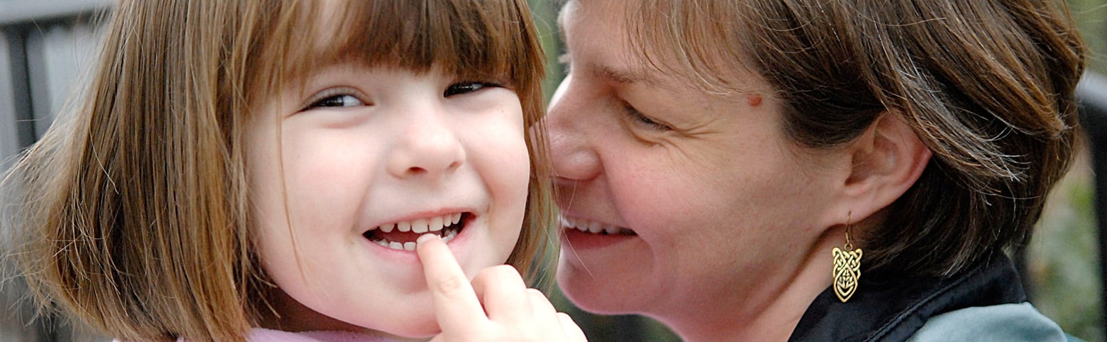 A portrait of a childcare provider and a child.