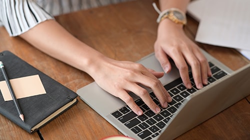 Cropped shot of businesswoman working and  using laptop computer