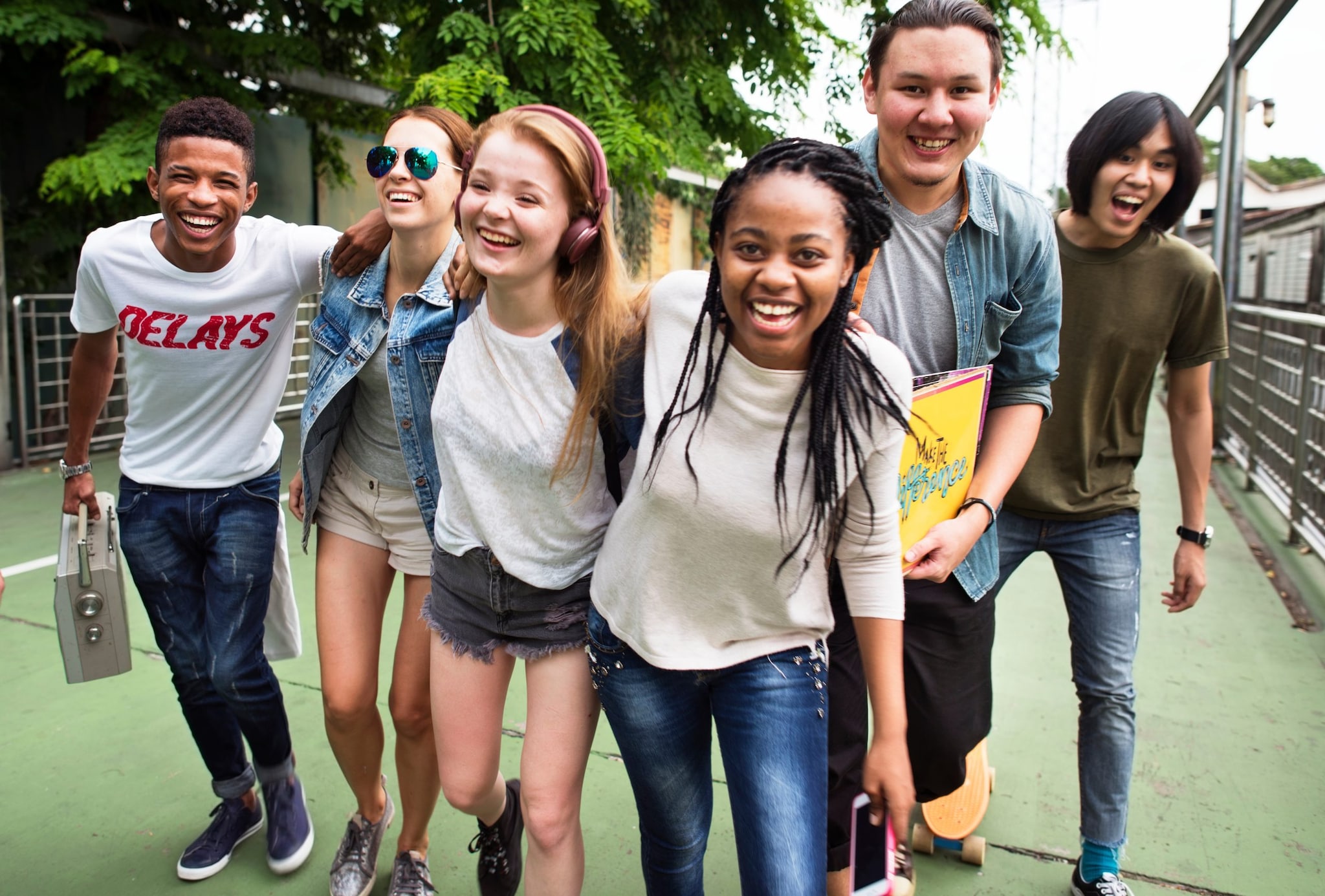 Diverse group of teenagers walking, laughing, and enjoying each other's company