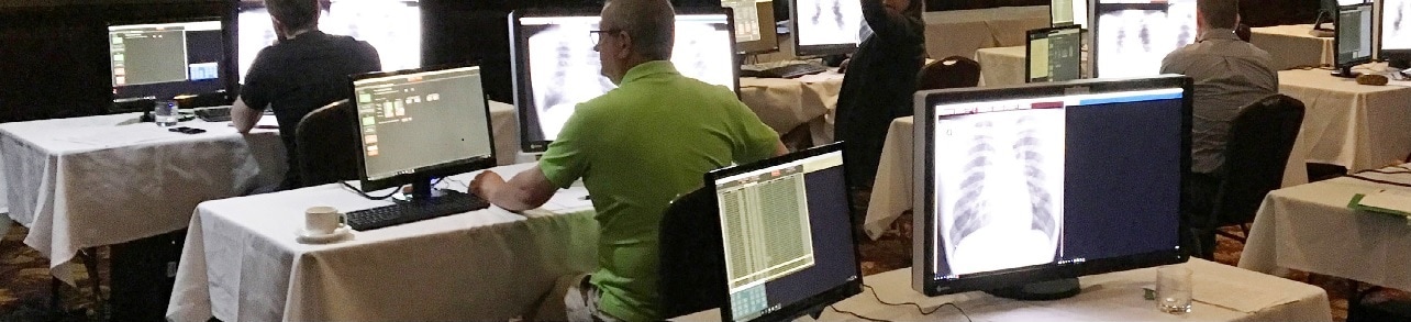 students seated at a computer in a conference